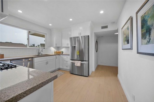 644 Kenoak Dr, Placentia, CA 92870 - kitchen with stainless steel appliances, white cabinets, light stone countertops, recessed lighting, and tasteful backsplash