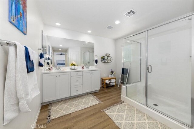 10757 Morgan Ct, Hesperia, CA 92345 - full bathroom featuring wood finished floors, double vanity, a stall shower, and recessed lighting