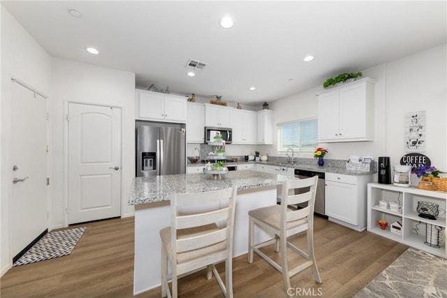 10757 Morgan Ct, Hesperia, CA 92345 - kitchen with stainless steel appliances, white cabinetry, a center island, and recessed lighting