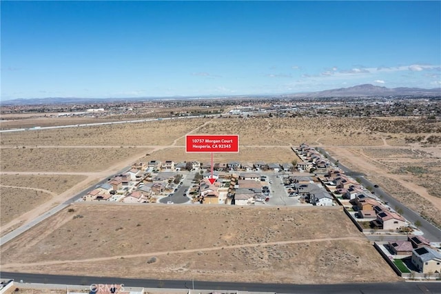 10757 Morgan Ct, Hesperia, CA 92345 - aerial overview of property's location with a mountain backdrop and rural landscape