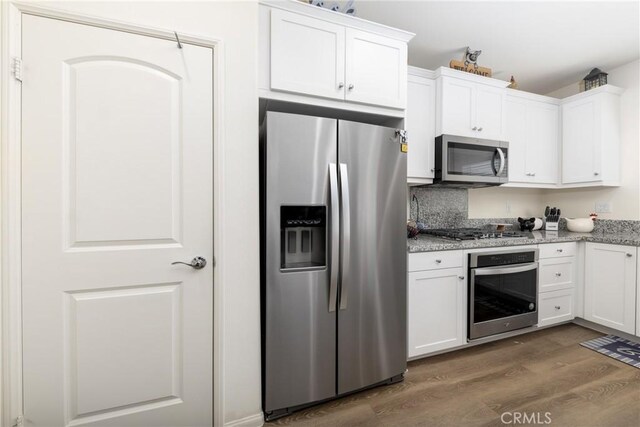 10757 Morgan Ct, Hesperia, CA 92345 - kitchen with stainless steel appliances, dark wood-type flooring, white cabinets, and light stone counters
