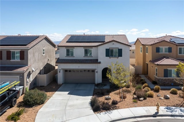 10757 Morgan Ct, Hesperia, CA 92345 - view of front facade with a tiled roof, stucco siding, concrete driveway, roof mounted solar panels, and a garage