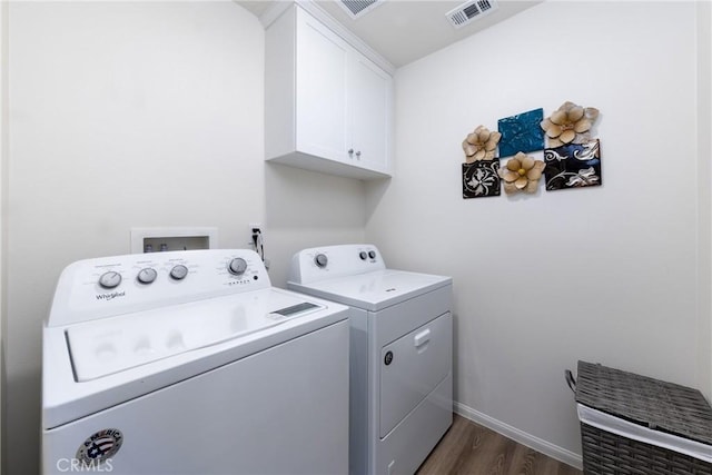 10757 Morgan Ct, Hesperia, CA 92345 - washroom with cabinet space, separate washer and dryer, and dark wood-style floors