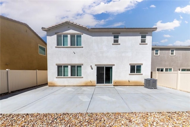10757 Morgan Ct, Hesperia, CA 92345 - back of house with a fenced backyard, stucco siding, and a patio area