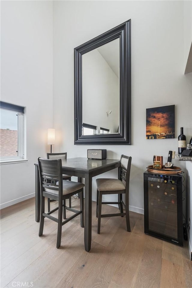 432 S Hamel Rd Unit 302, Los Angeles, CA 90048 - dining area with beverage cooler and light wood-style flooring