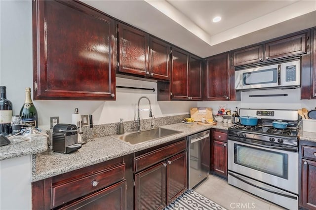 432 S Hamel Rd Unit 302, Los Angeles, CA 90048 - kitchen featuring appliances with stainless steel finishes, light tile patterned flooring, and dark brown cabinets