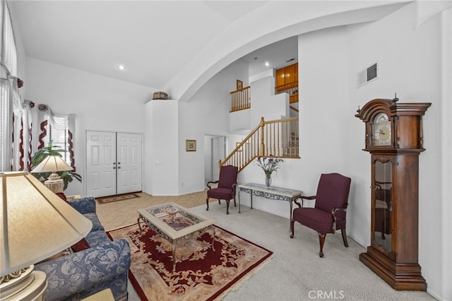 20865 Westbury Rd, Riverside, CA 92508 - living room with arched walkways, stairway, high vaulted ceiling, recessed lighting, and carpet floors