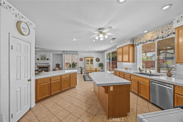 20865 Westbury Rd, Riverside, CA 92508 - kitchen featuring stainless steel dishwasher, a ceiling fan, tile counters, a fireplace, and recessed lighting