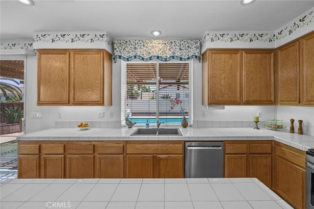20865 Westbury Rd, Riverside, CA 92508 - kitchen with dishwasher, light countertops, brown cabinets, and wallpapered walls