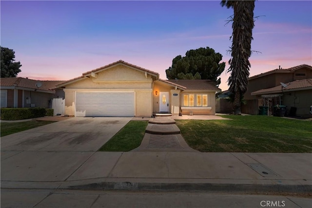 4633 Dowel Ave, Palmdale, CA 93552 - ranch-style home with a garage, a lawn, driveway, stucco siding, and a tile roof