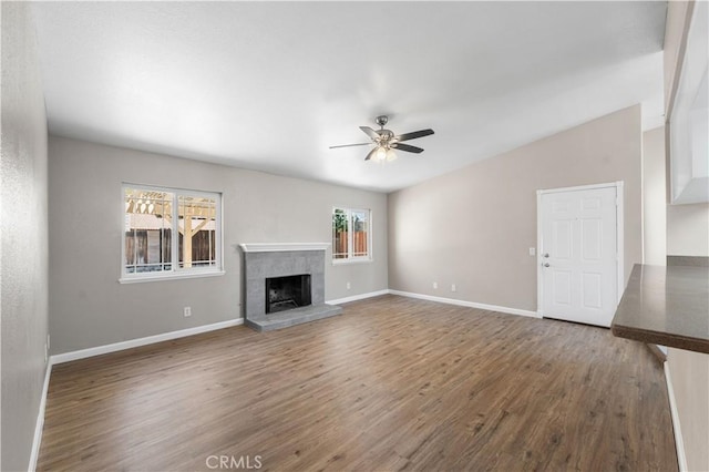 4633 Dowel Ave, Palmdale, CA 93552 - unfurnished living room featuring a ceiling fan, wood finished floors, and a fireplace