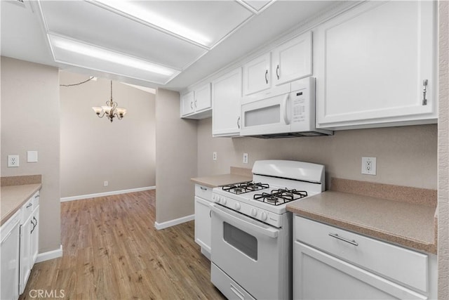 4633 Dowel Ave, Palmdale, CA 93552 - kitchen with white appliances, a chandelier, white cabinets, and light wood-style flooring