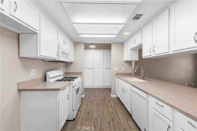 4633 Dowel Ave, Palmdale, CA 93552 - kitchen featuring white appliances, white cabinets, wood finished floors, and light countertops