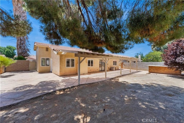 4633 Dowel Ave, Palmdale, CA 93552 - rear view of property featuring stucco siding, a patio area, a fenced backyard, and a pergola