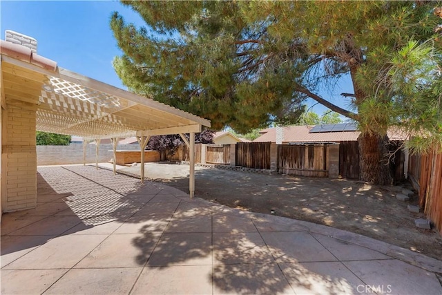 4633 Dowel Ave, Palmdale, CA 93552 - fenced backyard with a pergola, a patio, and a carport