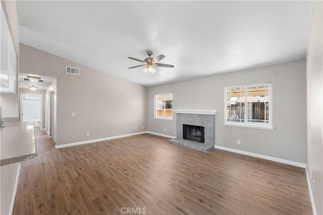4633 Dowel Ave, Palmdale, CA 93552 - unfurnished living room with ceiling fan, wood finished floors, and a tile fireplace