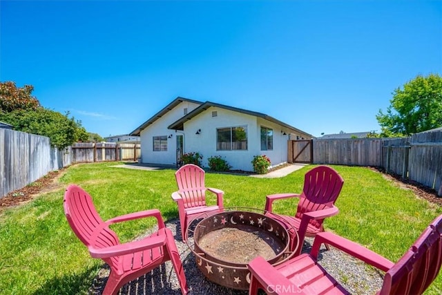 1066 Maple St, Arroyo Grande, CA 93420 - rear view of house with a fire pit, a fenced backyard, and stucco siding