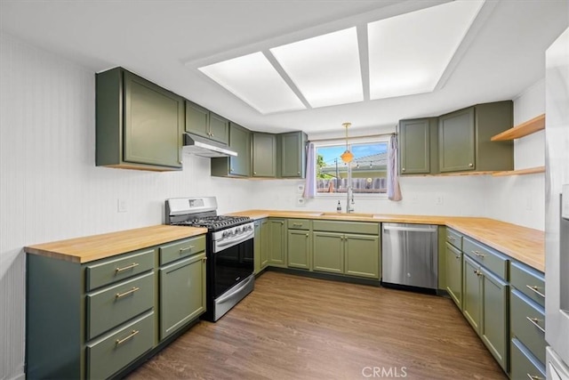 1066 Maple St, Arroyo Grande, CA 93420 - kitchen featuring green cabinets, appliances with stainless steel finishes, under cabinet range hood, open shelves, and dark wood-style flooring
