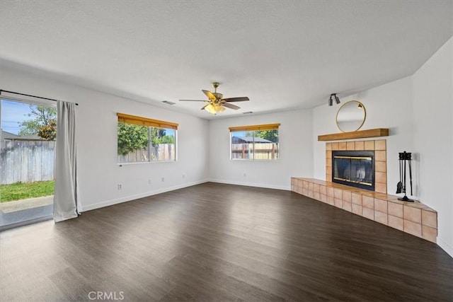 1066 Maple St, Arroyo Grande, CA 93420 - unfurnished living room featuring wood finished floors, a fireplace, a ceiling fan, and a textured ceiling