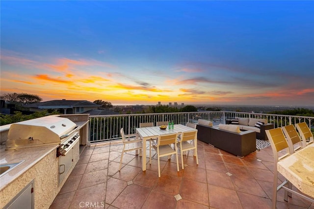 11 Montpellier Unit 22, Newport Beach, CA 92660 - patio terrace at dusk featuring outdoor lounge area, a patio area, an outdoor kitchen, and outdoor dining area