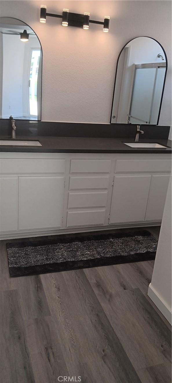 720 Big Spring Dr, Banning, CA 92220 - bathroom featuring double vanity and wood finished floors