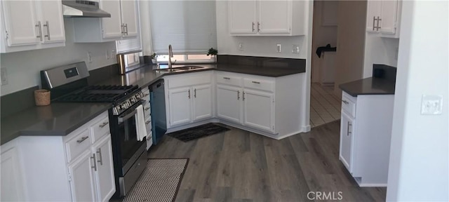 720 Big Spring Dr, Banning, CA 92220 - kitchen with gas range, under cabinet range hood, white cabinets, and dark wood finished floors