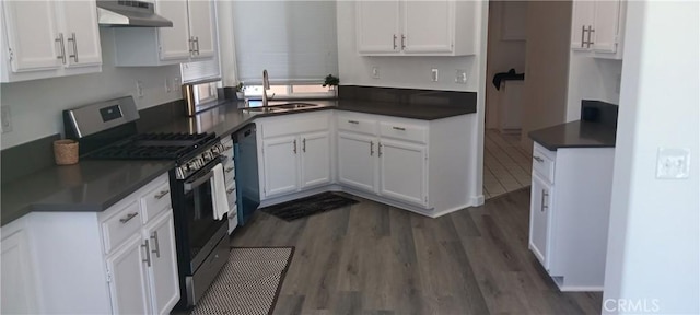 720 Big Spring Dr, Banning, CA 92220 - kitchen with gas range, under cabinet range hood, white cabinets, and dark wood-style floors