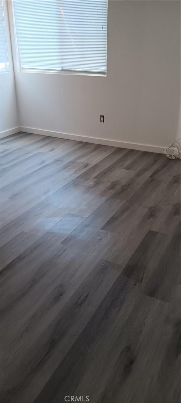 720 Big Spring Dr, Banning, CA 92220 - spare room featuring dark wood-style flooring and baseboards