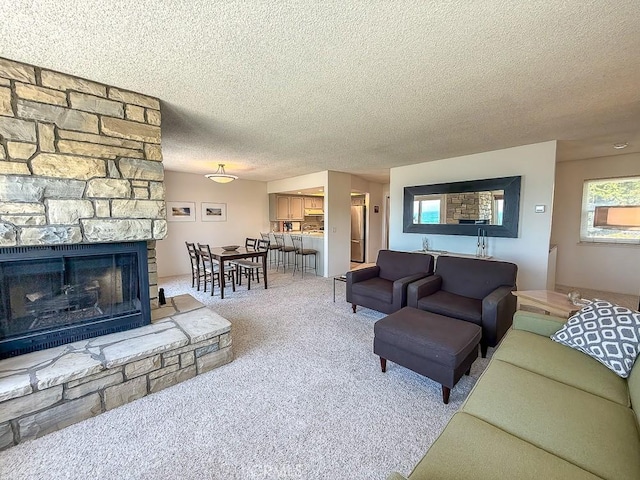 557 Lucerne St, Cayucos, CA 93430 - carpeted living area featuring a textured ceiling and a stone fireplace