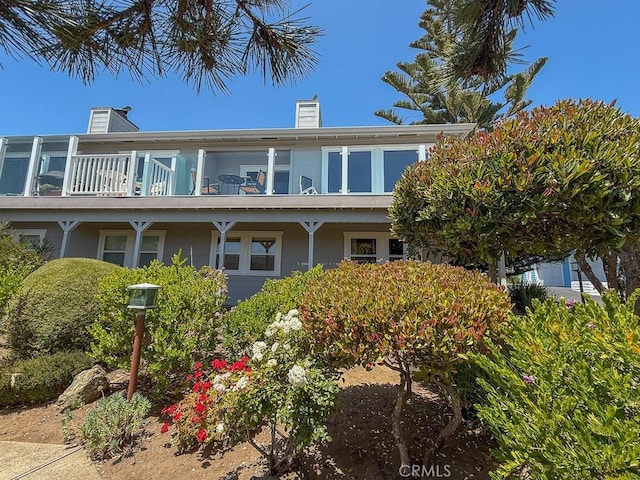 557 Lucerne St, Cayucos, CA 93430 - back of property featuring a chimney and a balcony