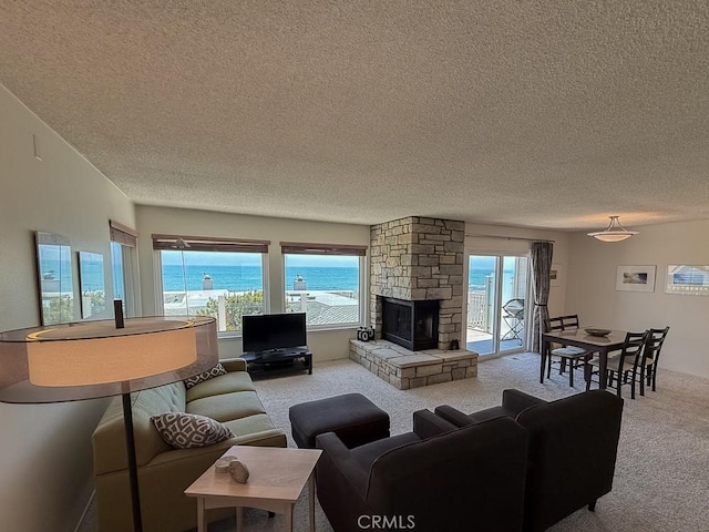 557 Lucerne St, Cayucos, CA 93430 - living room with a textured ceiling, carpet flooring, and a stone fireplace