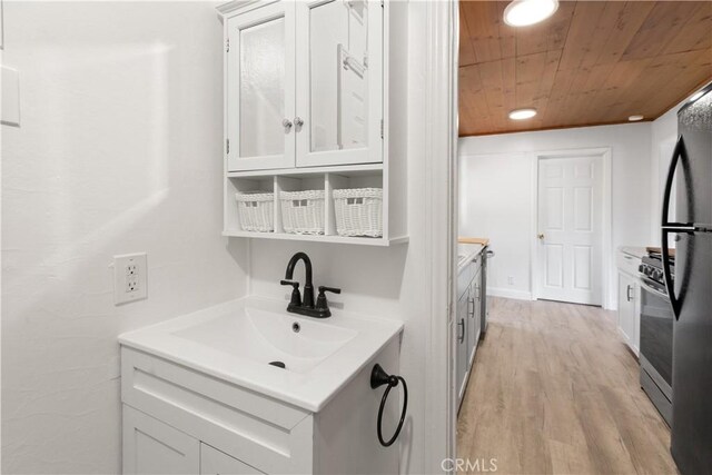 1777 Sparrow Rd, Wrightwood, CA 92397 - kitchen with wood ceiling, white cabinetry, light wood-style floors, light countertops, and stainless steel gas range oven