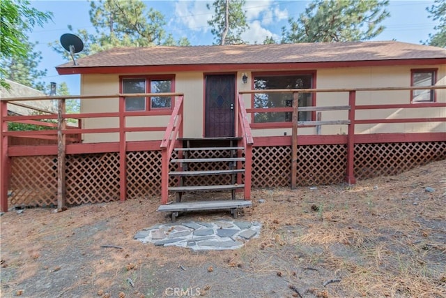 1777 Sparrow Rd, Wrightwood, CA 92397 - back of property with a deck and roof with shingles