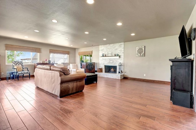 90 E Emerson St, Chula Vista, CA 91911 - living room featuring a fireplace, wood finished floors, recessed lighting, healthy amount of natural light, and a textured ceiling