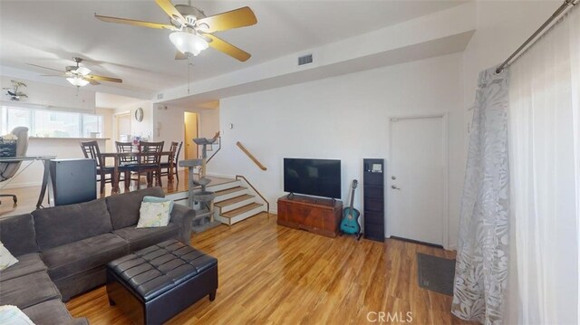 21602 Figueroa St Unit 25, Carson, CA 90745 - living room with light wood finished floors, a ceiling fan, and stairway