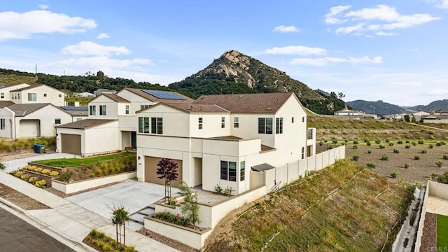 35188 Orchard Trl, Fallbrook, CA 92028 - view of side of property with concrete driveway, a mountain view, stucco siding, an attached garage, and a residential view