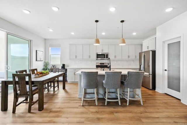 35188 Orchard Trl, Fallbrook, CA 92028 - kitchen with stainless steel appliances, light countertops, a center island with sink, backsplash, and recessed lighting