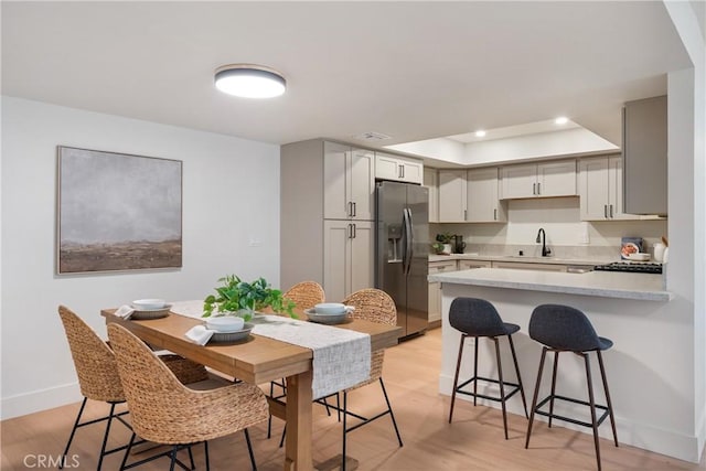 25564 Sharp Dr Unit G, Hemet, CA 92544 - dining room with recessed lighting, light wood-type flooring, and a tray ceiling