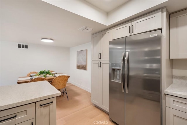 25564 Sharp Dr Unit G, Hemet, CA 92544 - kitchen with stainless steel refrigerator with ice dispenser, light wood finished floors, light countertops, and gray cabinets
