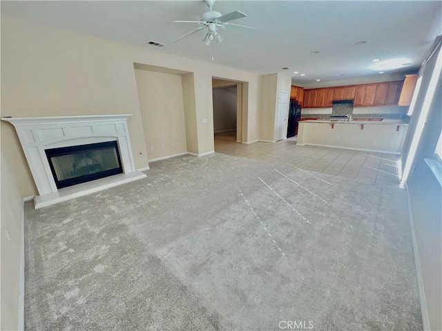 3642 Neola Way, Lancaster, CA 93536 - unfurnished living room with light carpet, ceiling fan, a glass covered fireplace, and recessed lighting