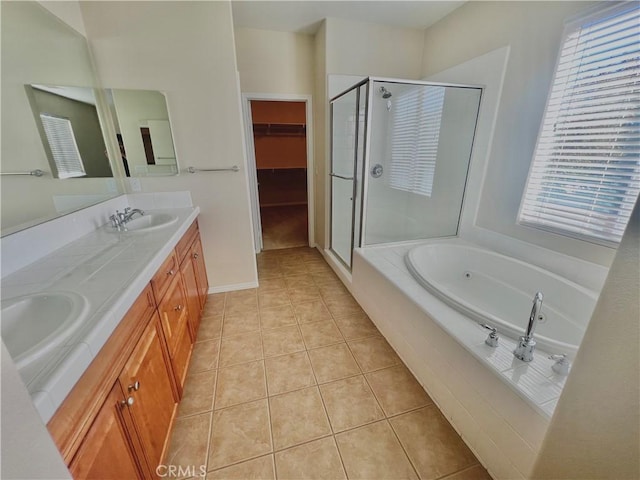3642 Neola Way, Lancaster, CA 93536 - bathroom featuring a stall shower, a bath, double vanity, a walk in closet, and tile patterned floors