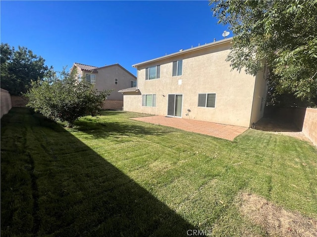 3642 Neola Way, Lancaster, CA 93536 - rear view of house with a yard, stucco siding, and a patio area