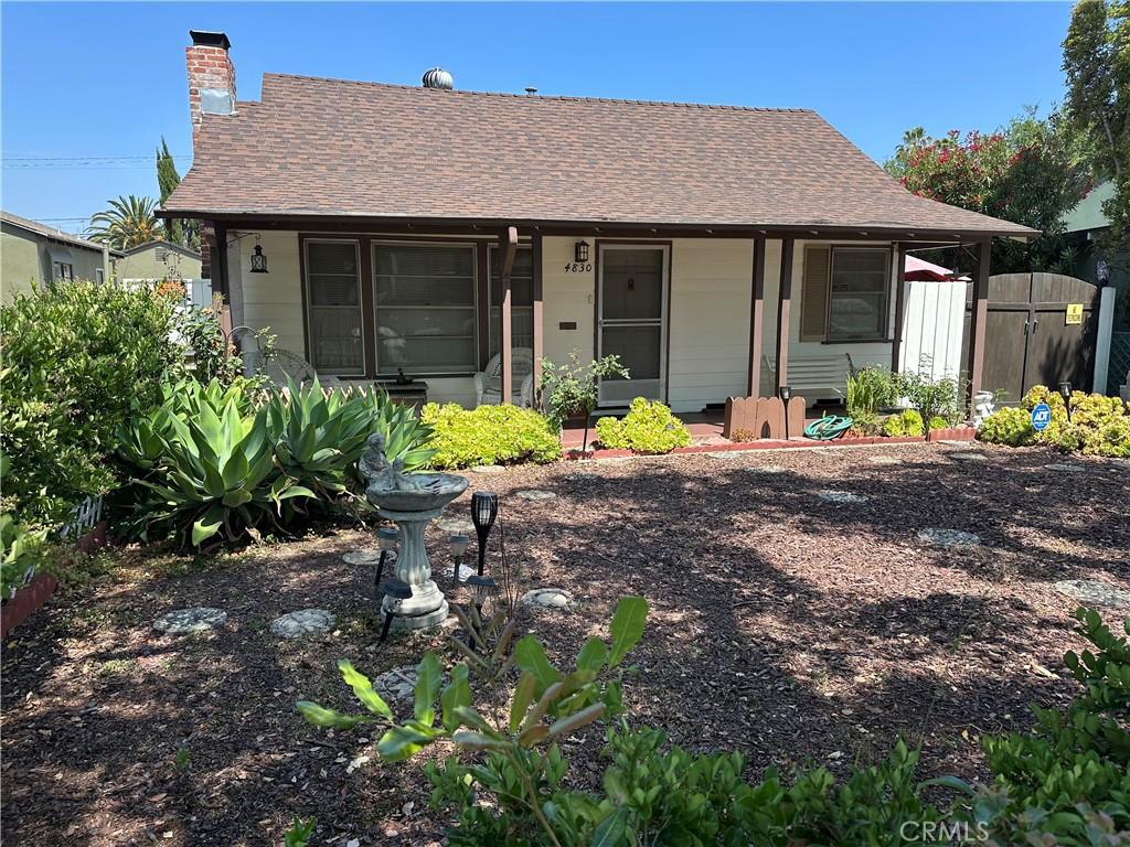 4830 Sancola Ave, North Hollywood, CA 91601 - view of front of property featuring a chimney, a gate, a shingled roof, and covered porch