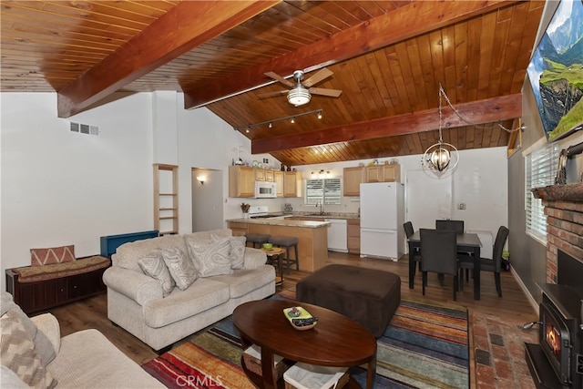 31449 Onacrest Dr, Running Springs, CA 92382 - living area featuring wood ceiling, a wood stove, wood finished floors, ceiling fan, and a chandelier