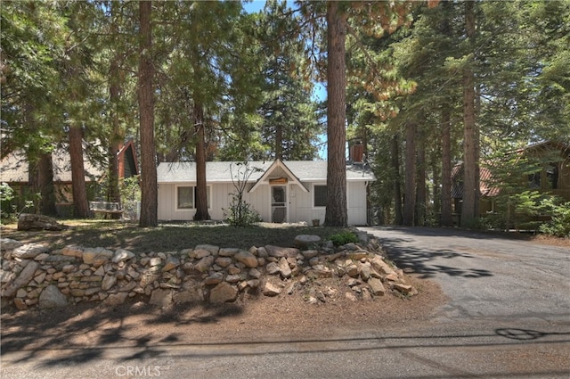 31449 Onacrest Dr, Running Springs, CA 92382 - view of front of house with asphalt driveway, a chimney, and a garage