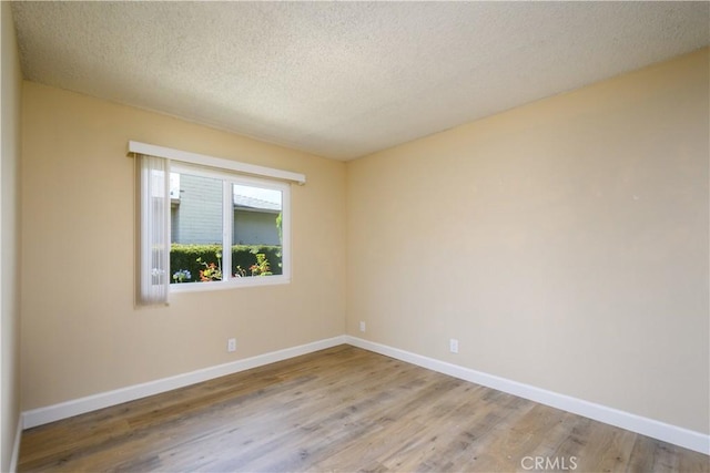 1881 Mitchell Ave Unit 8, Tustin, CA 92780 - empty room featuring a textured ceiling and wood finished floors