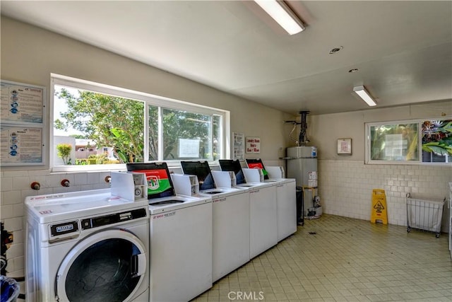 1881 Mitchell Ave Unit 8, Tustin, CA 92780 - shared laundry room with washing machine and dryer, water heater, tile walls, and a wainscoted wall