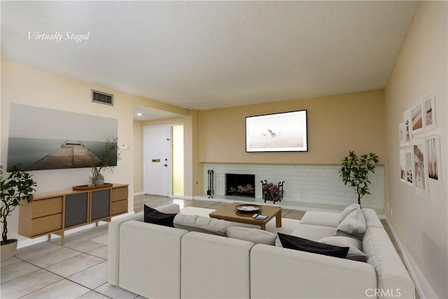 1881 Mitchell Ave Unit 8, Tustin, CA 92780 - living room with a textured ceiling, light tile patterned flooring, and a fireplace