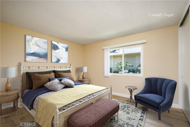 1881 Mitchell Ave Unit 8, Tustin, CA 92780 - bedroom featuring wood finished floors and a textured ceiling