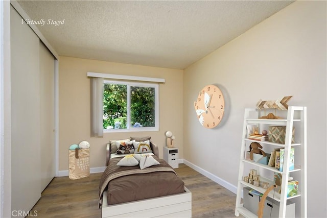 1881 Mitchell Ave Unit 8, Tustin, CA 92780 - bedroom featuring wood finished floors, a textured ceiling, and a closet